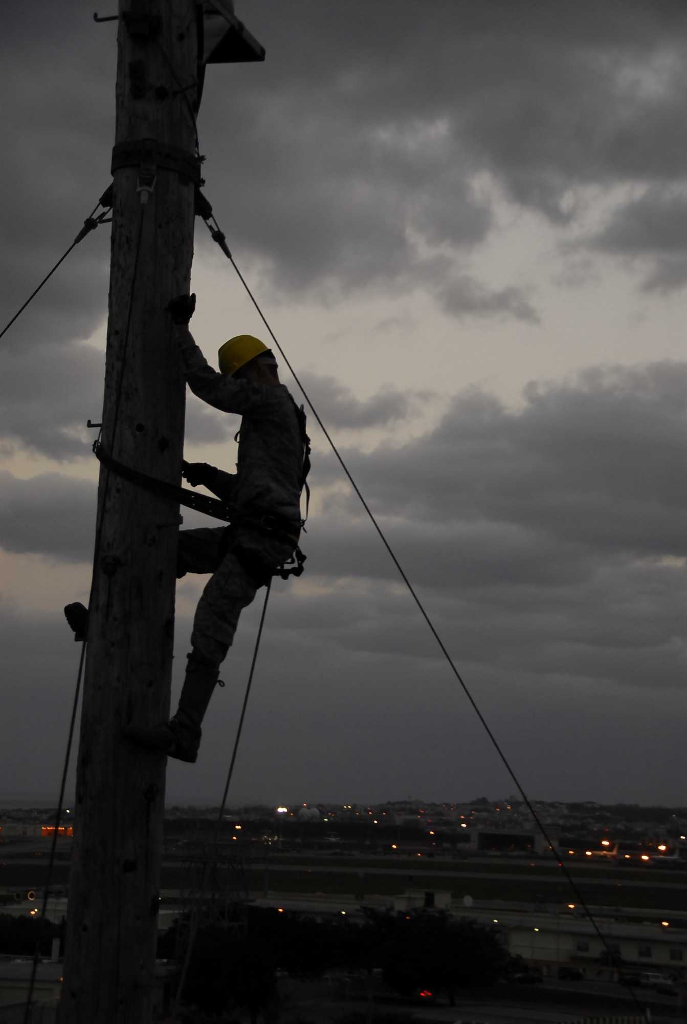 Airman 1st Class Brandon Courtain-Tharp, 18th Communications Squadron cable and antenna systems technician, ascends a 90-foot, air-to-ground communication antenna pole for a semi-annual preventative maintenance inspection near Kadena’s flight line, March 8. During the inspection, technicians perform corrosion control techniques on metallic connectors to preserve communication connectivity. (U.S. Air Force photo/Airman 1st Class Maeson L. Elleman)