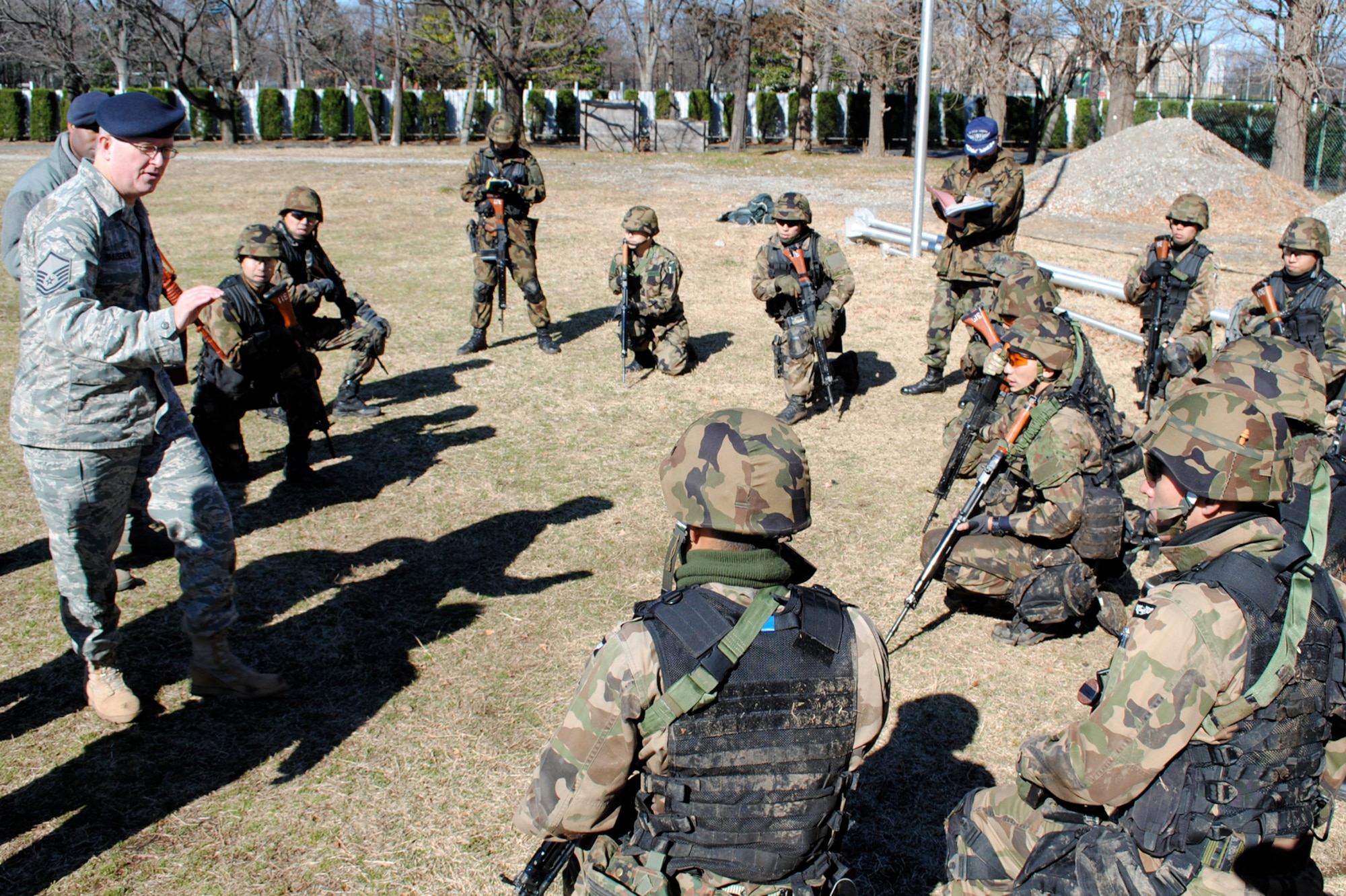 FUCHU AIR BASE, Japan -- Master Sgt. Eric Haeseker, 5th Air Force A7s manager, instructs security guards from the Japan Air Self Defense Force on the importance of communicating as a team during team movement tactics here Mar. 4. 5th Air Force and 374th Security Forces Squadron Airmen are helping JASDF transform its security guard training and operations into something more similar to U.S. Air Force security forces as JASDF prepares to stand up its new Base Defense Development and Training Squadron. (U.S. Air Force photo/Capt. Will Powell)