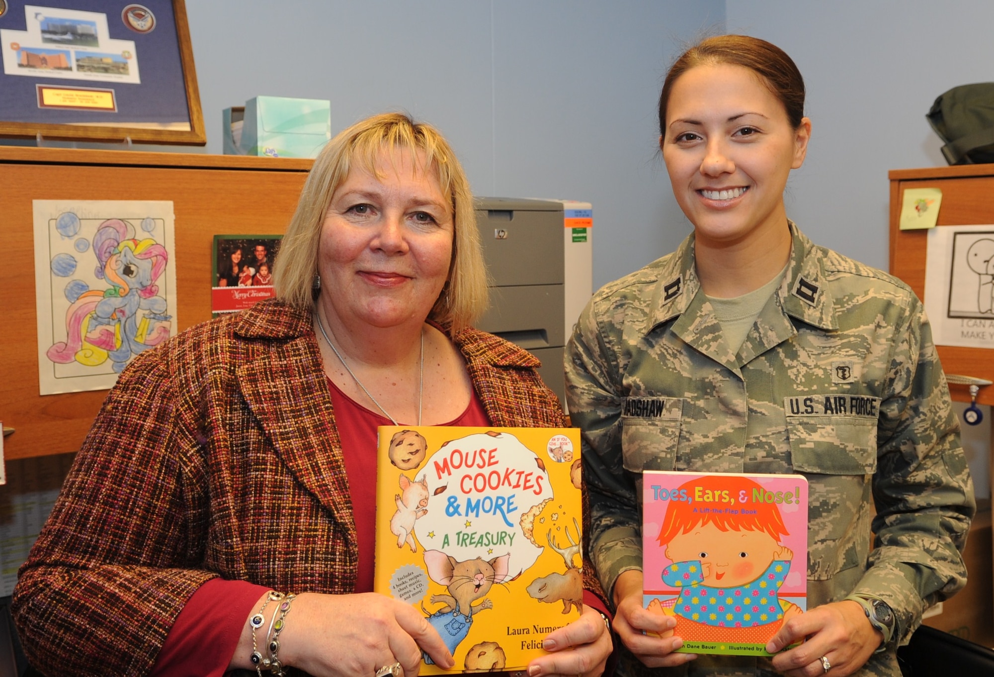 Holly Mello, a 39th Medical Group developmental specialist, and Capt. Linda Bradshaw, the 39th MDG pediatrician, pose for a photo March 3, 2011 during the kickoff of the Reach Out and Read program at Incirlik Air Base, Turkey.  Mrs. Mello and Captain Bradshaw are the two individuals who initiated the program at Incirlik, allowing Incirlik to become the first Air Force installation overseas to implement this program.  Reach Out and Read is an evidence-based nonprofit organization that promotes early literacy and school readiness in pediatric exam rooms nationwide by giving new books to children and advice to parents about the importance of reading aloud.  (U.S. Air Force photo by Airman 1st Class Clayton Lenhardt/Released)