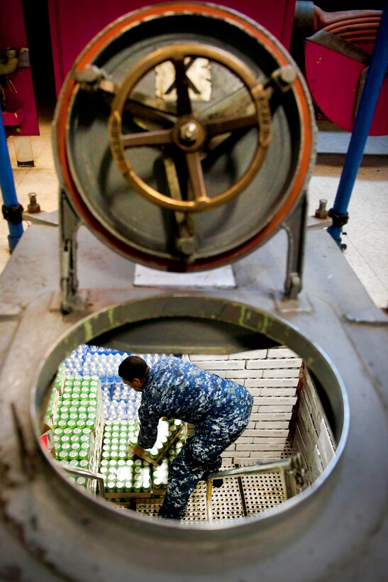 U.S. Navy Seaman Antonio Thomas moves soda from a store room on the aircraft carrier USS Carl Vinson which is under way in the Arabian Sea, March 1, 2011. Thomas is assigned to the supply department.