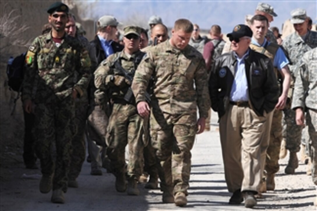 Secretary of Defense Robert M. Gates speaks with International Security Assistance Force member and platoon leader Lt. Viti at Combat Outpost Kowall in Afghanistan on March 8, 2011.  