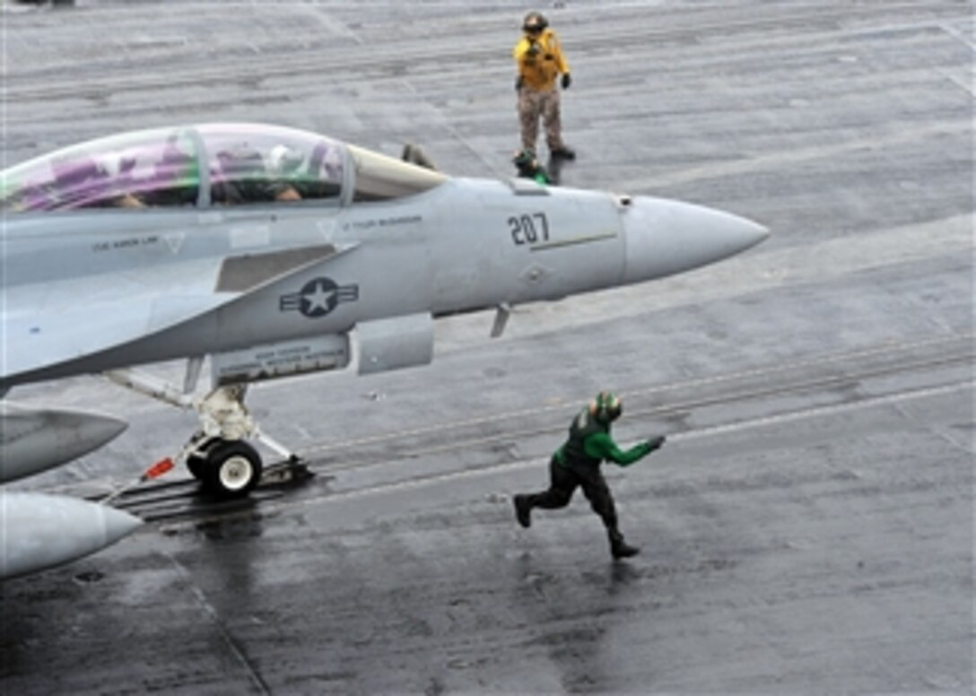 An F/A-18F Super Hornet aircraft assigned to Strike Fighter Squadron 211 prepares to launch from catapult three during cyclic flight operations aboard the aircraft carrier USS Enterprise (CVN 65).  The Enterprise and Carrier Air Wing 1 are on routine deployment conducting maritime security operations in the U.S. 5th Fleet area of responsibility.  