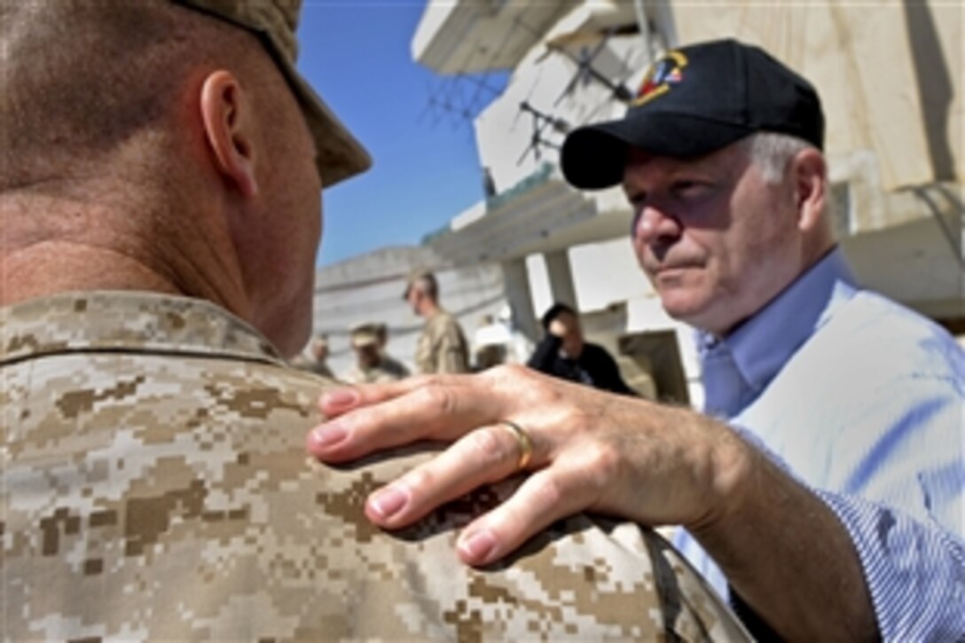 U.S. Defense Secretary Robert M. Gates thanks U.S. Marine Lt. Col Jason L. Morris for his leadership and his team's sacrifice on Forward Operating Base Sabit Qadam in Afghanistan, March 8, 2011. Morris is the commander of the 3rd Battalion, 5th Marine Regiment.