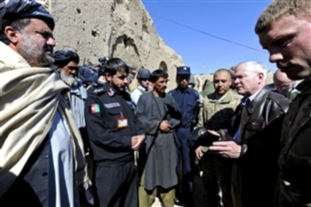 U.S. Defense Secretary Robert M. Gates speaks with elders, members of the village council and the district police chief during a village visit outside Combat Outpost Kowall in Afghanistan, March 8, 2011.
