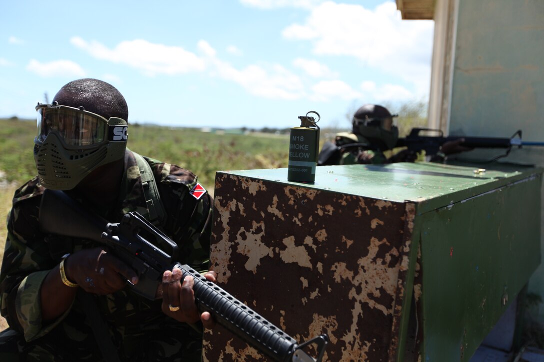 Soldiers for the Trinidad and Tobago Defense Force, scan the area for enemy combatants during close quarters battle training, March 8, as part of exercise Tradewinds 2011.::r::::n::