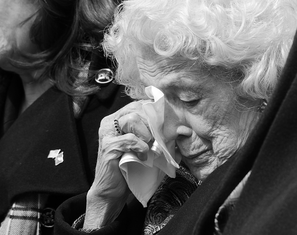 Mrs. Luther Dockery wipes away tears from her eyes using a handkerchief during the funeral of her son, Col. Charles Dockery, at Arlington National Cemetery March 8. Dockery retired from the Marine Corps in 2002 after 36 years of service. (Photo by Cpl. Bobby J. Yarbrough/RELEASED)