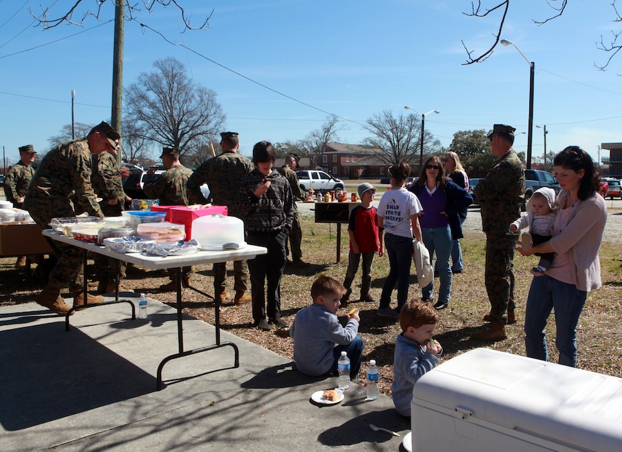 Marines and Sailors with the 24th Marine Expeditionary Unit's Command Element and their families enjoy a lunch together during a barbecue March 8, at the 24th MEU Headquarters Building.