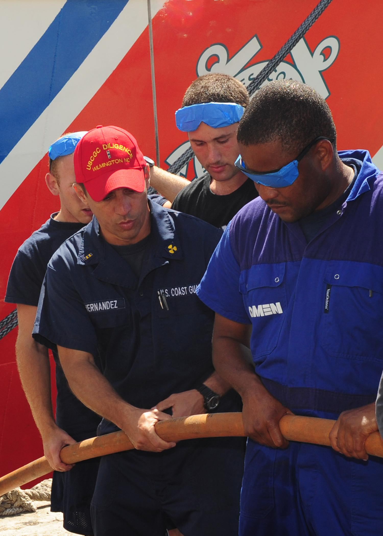 Chief Warrant Officer Mike Hernandez, the main propulsion assistant and member of the Damage Control Training Team aboard the U.S. Coast Guard Cutter Diligence, explains proper hose-handling techniques to a simulated firefighting team composed of Coast Guardsmen from the United States and Barbados during a shipboard firefighting demonstration during Exercise Tradewinds 2011, March 9. Tradewinds is an annual exercise designed to build relationships and enhance stability and inter-operability throughout the Caribbean region. (U.S. Coast Guard photo by Petty Officer 3rd Class George Degener)