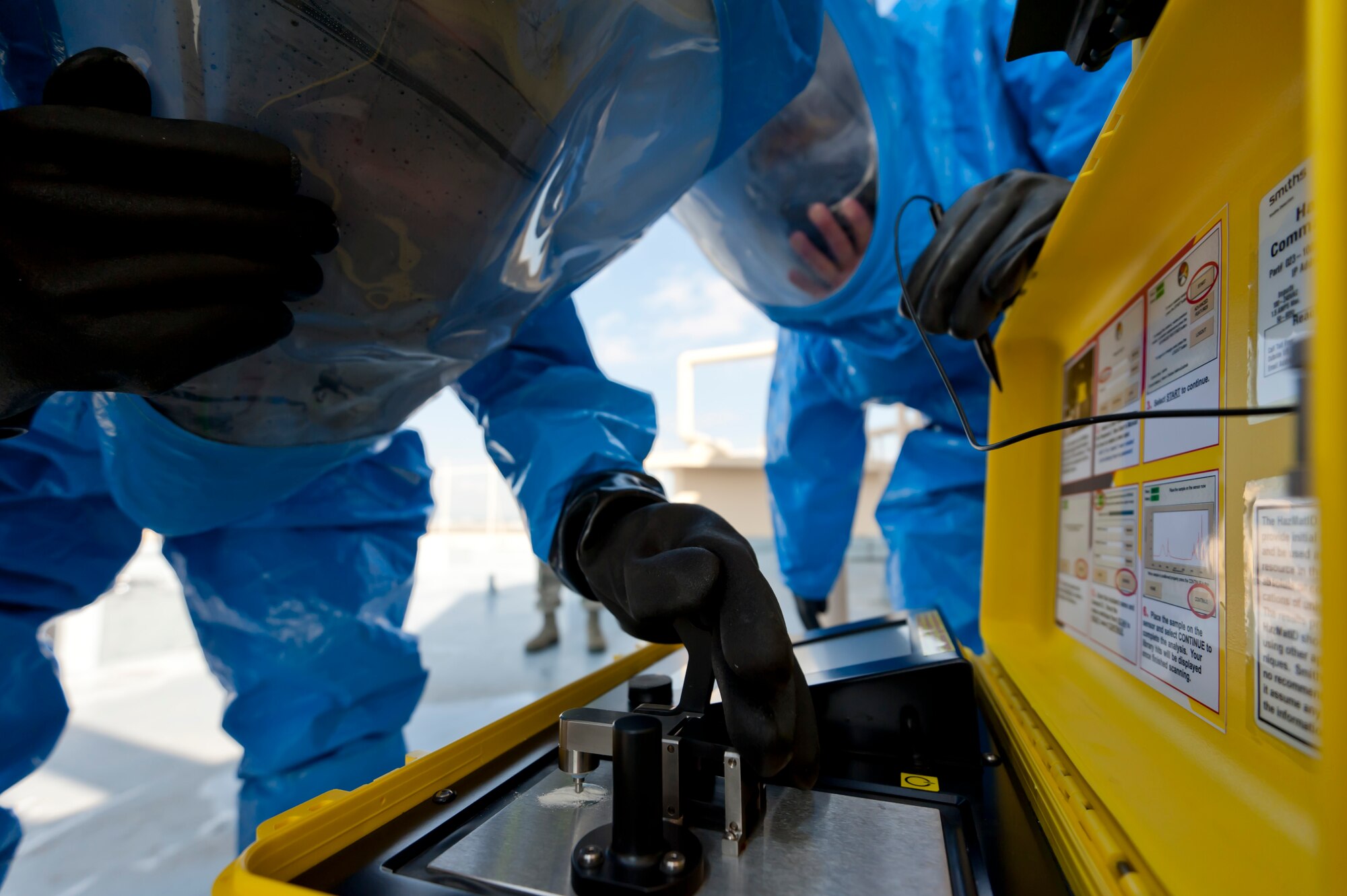 YOKOTA AIR BASE, Japan -- Senior Airman Richard Riley, 374th Aerospace Medicine Squadron bio-environmental engineering technician, and Senior Airman Travis McCallum, 374th Civil Engineer Squadron emergency management technician, identify a sample of a simulated suspicious substance found at a residential tower during an Operational Readiness Exercise here March 9. During the scenario, a substance was found during a 374th Security Forces Squadron building sweep following a simulated call regarding vandalism. (U.S. Air Force photo/Staff Sgt. Samuel Morse)