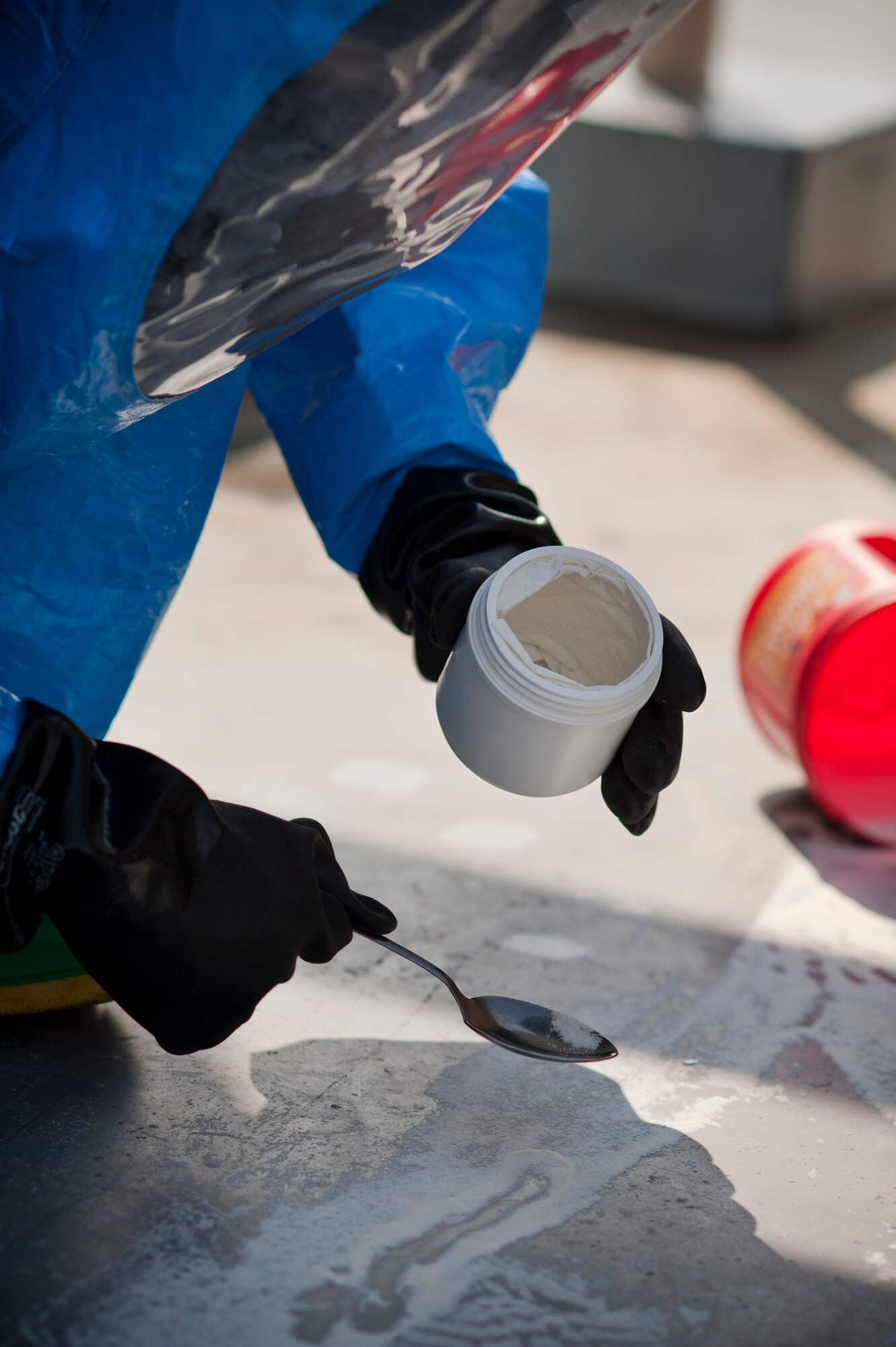 YOKOTA AIR BASE, Japan -- Senior Airman Travis McCallum, 374th Civil Engineer Squadron emergency management technician, collects a sample of a simulated suspicious substance found at a residential tower during an Operational Readiness Exercise here March 9. The substance needed to be identified before a decision could be made by emergency management personnel on how to make the tower safe again for its residents. (U.S. Air Force photo/Staff Sgt. Samuel Morse)
