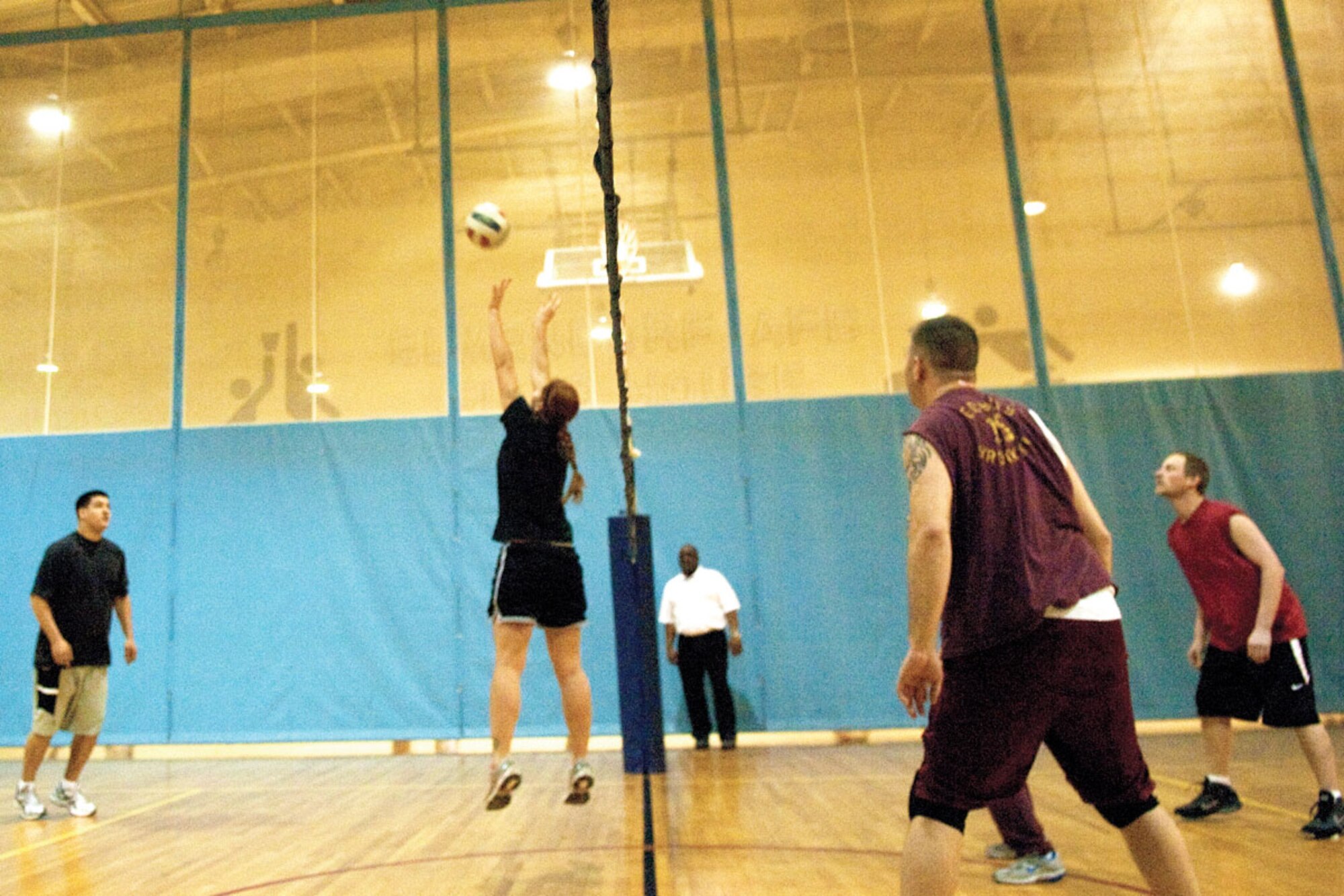 Members of the 673d Civil Engineer Squadron’s intramural volleyball team (left) set for a spike during a game against the 673d Contracting Squadron team. The teams played two matches switching sides after the first. The 673d CES won both matches, 25-20 in the first and 25-21 in the second. (U.S. Air Force photo/Airman 1st Class Jack Sanders)