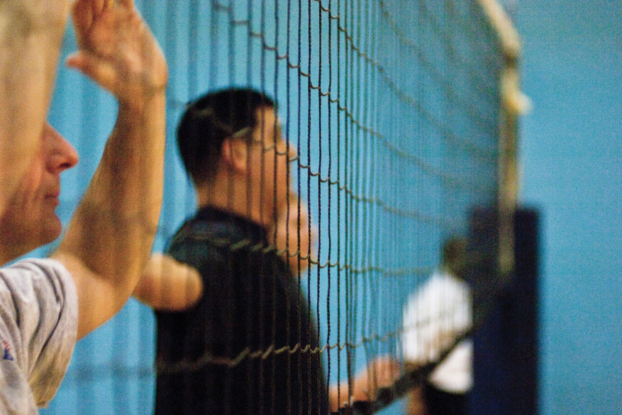 Members of the 673d Civil Engineer Squadron’s intramural volleyball team line up at before a serve during a game against the 673d Contracting Squadron team. The teams played two matches switching sides after the first. The 673d CES won both matches, 25-20 in the first and 25-21 in the second. (U.S. Air Force photo/Airman 1st Class Jack Sanders)