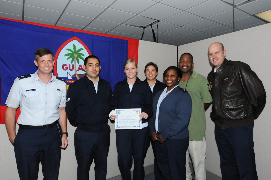 Airman 1st Class Katherine Beshoner, 36 Operations Support Squadron aviation resource management journeyman, poses with her co-workers after receiving the Andersen’s Best award, March 7.  Because of her hard work and dedication, Airman Beshoner was nominated by her fellow workers for becoming a phenomenal asset to the operations and plans section by securing phone and computer capabilities, changing safes and vault combos and organizing supplies and equipment during the bed-down of the 13 AF staff and operational flying forces. (U.S. Air Force photo/ Senior Airman Carlin Leslie)