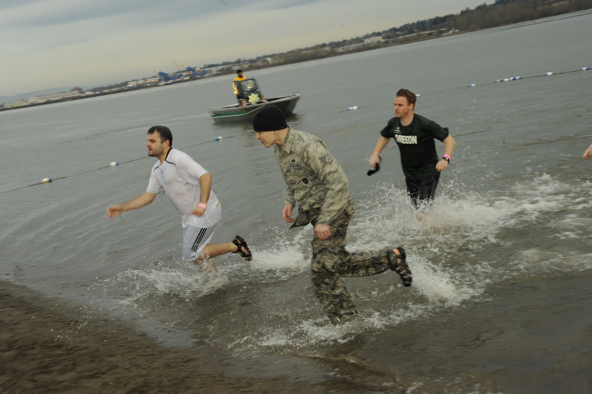 Oregon Air National Guard Staff Sgt. Jarrod Johnson, a member of the 142nd Fighter Wing in Portland, Ore., runs from the Columbia River on the morning of February 12, 2011 during the Super Polar Plunge. The 21 Super Plungers raised 65,000 dollars for Special Olympics of Oregon as they jumped in the water every hour for 24 straight hours. The 142nd Fighter Wing provided tents, heaters and other equipment for the event. (U.S. Air Force photograph by Tech. Sgt. John Hughel, 142nd Fighter Wing Public Affairs)
