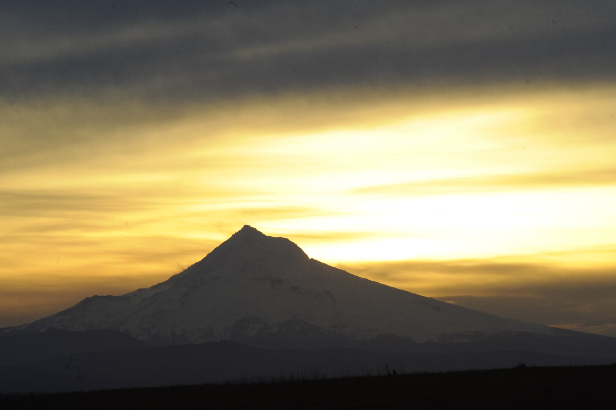 Sunrise over Mt. Hood, Oregon on the Columbia River, in Portland, Ore.,site of the 2011 Polar Plunge. The 21 "Super Plungers" jumped in the river every hour for 24 hours and finished on the morning of February 12, 2011. (U.S. Air Force photograph by Tech. Sgt. John Hughel, 142nd Fighter Wing Public Affairs)