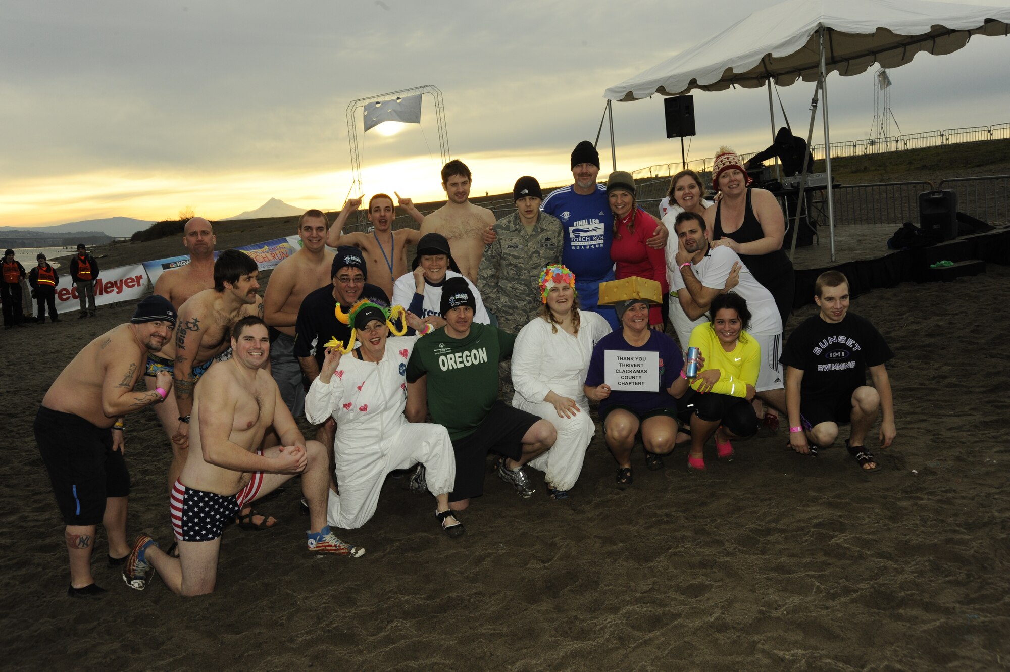 The 21 "super plunger", who raised more the 65,000 dollars for the Oregon Special Olympics pose for a photograph on February 12, 2001. The one 142nd Fighter Wing helped with tents and heaters so they could jump in the river every hour for 24 straight hours on February 11-12, 2001. (U.S. Air Force photograph by Tech. Sgt. John Hughel, 142nd Fighter Wing Public Affairs)