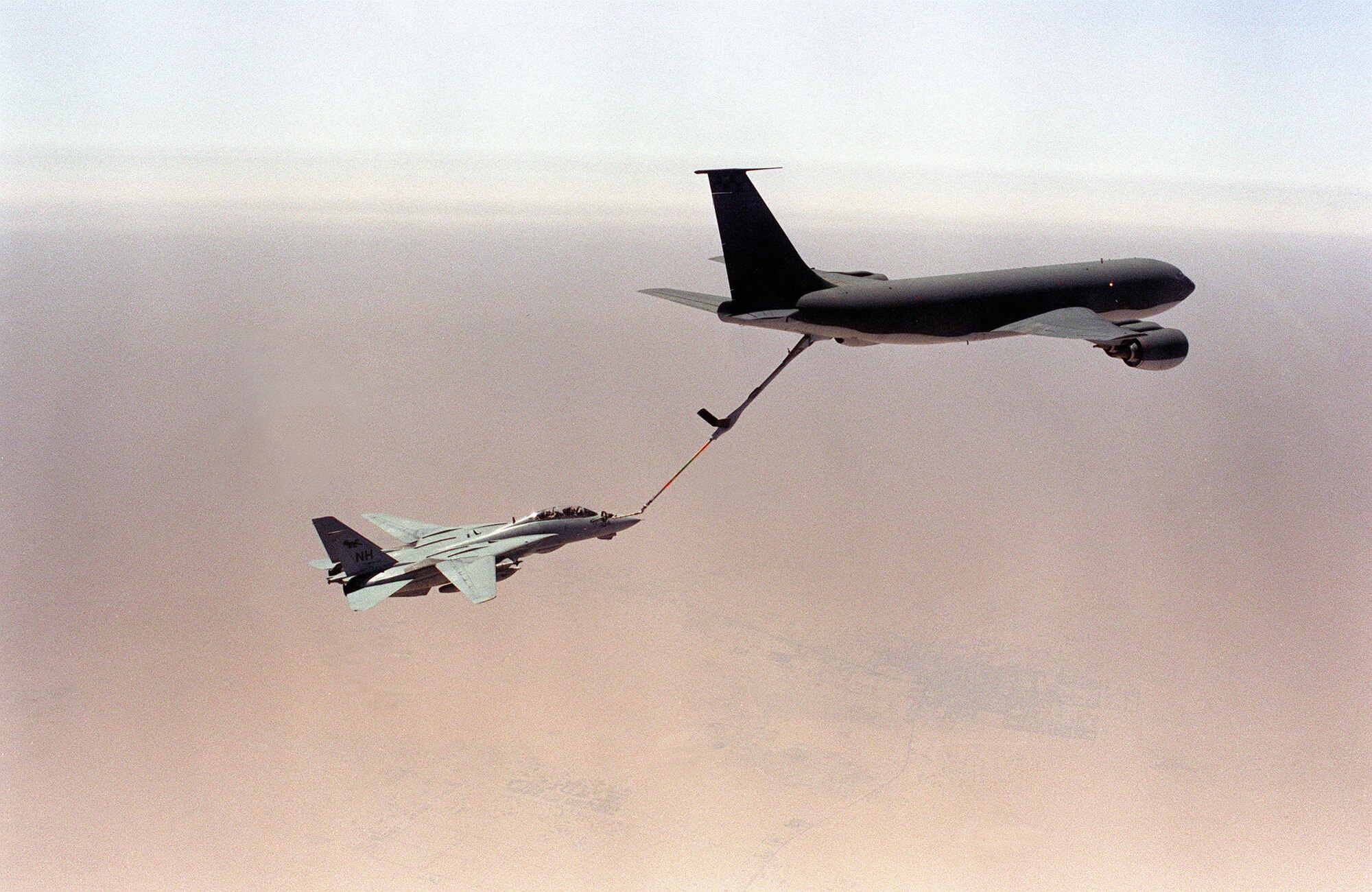 A KC-135 Stratotanker refuels a U.S. Navy fighter during air operations for Operation Desert Storm in January 1991. (Department of Defense Photo)


