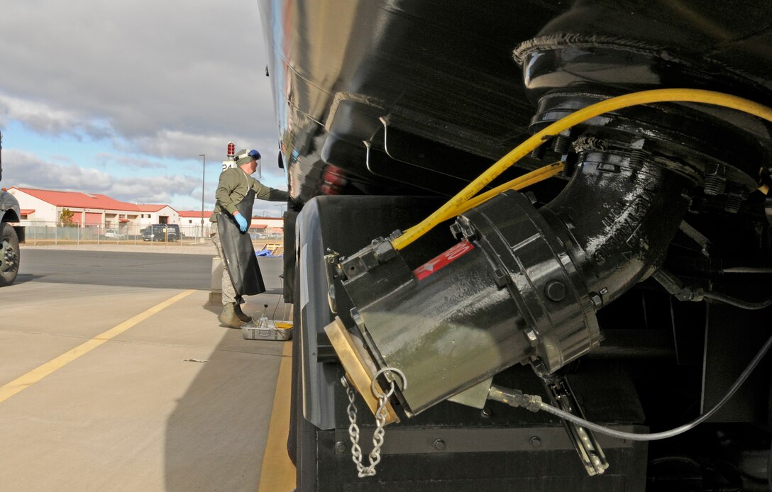 Staff Sgt. James Hubbard prepares to draw a sample of fuel from one of the tanker trucks used to transport fuel to the flightline and to the fleet of F-15 aircraft at Kingsley Field.