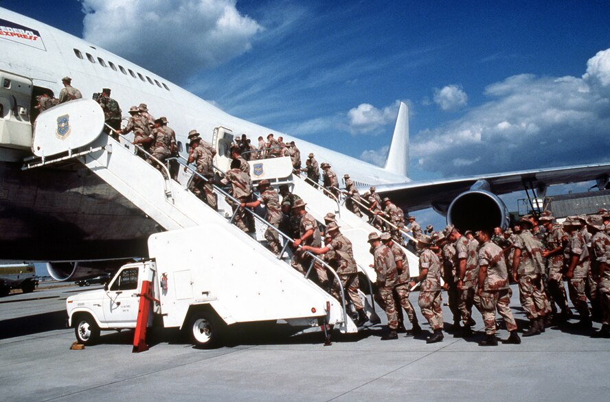Marines headed to support the coalition forces participating in Operation Desert Shield board a commercial aircraft chartered by the Military Airlift Command in September 1991. (Department of Defense Photo)
