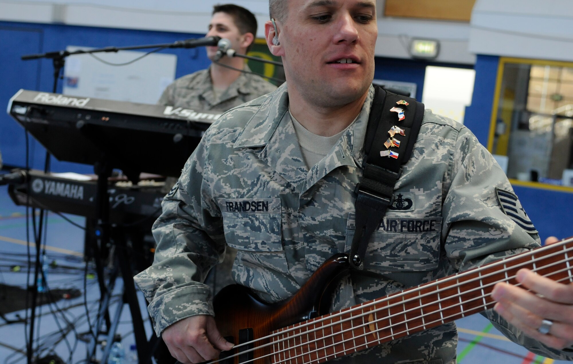 HOHENFELS, Germany – Tech. Sgt. Mark Frandsen, U.S. Air Forces in Europe Band Touch ‘n Go NCO in charge and bassist, performs for a gymnasium packed with students and teachers at Hohenfels Middle and High School on U.S. Army Garrison Hohenfels, Germany, March 8. Touch ‘n Go performed for more than 300 students at the school as part of a Music in Our Schools tour throughout Bavaria. (U.S. Air Force photo/Staff Sgt. Kali L. Gradishar)
