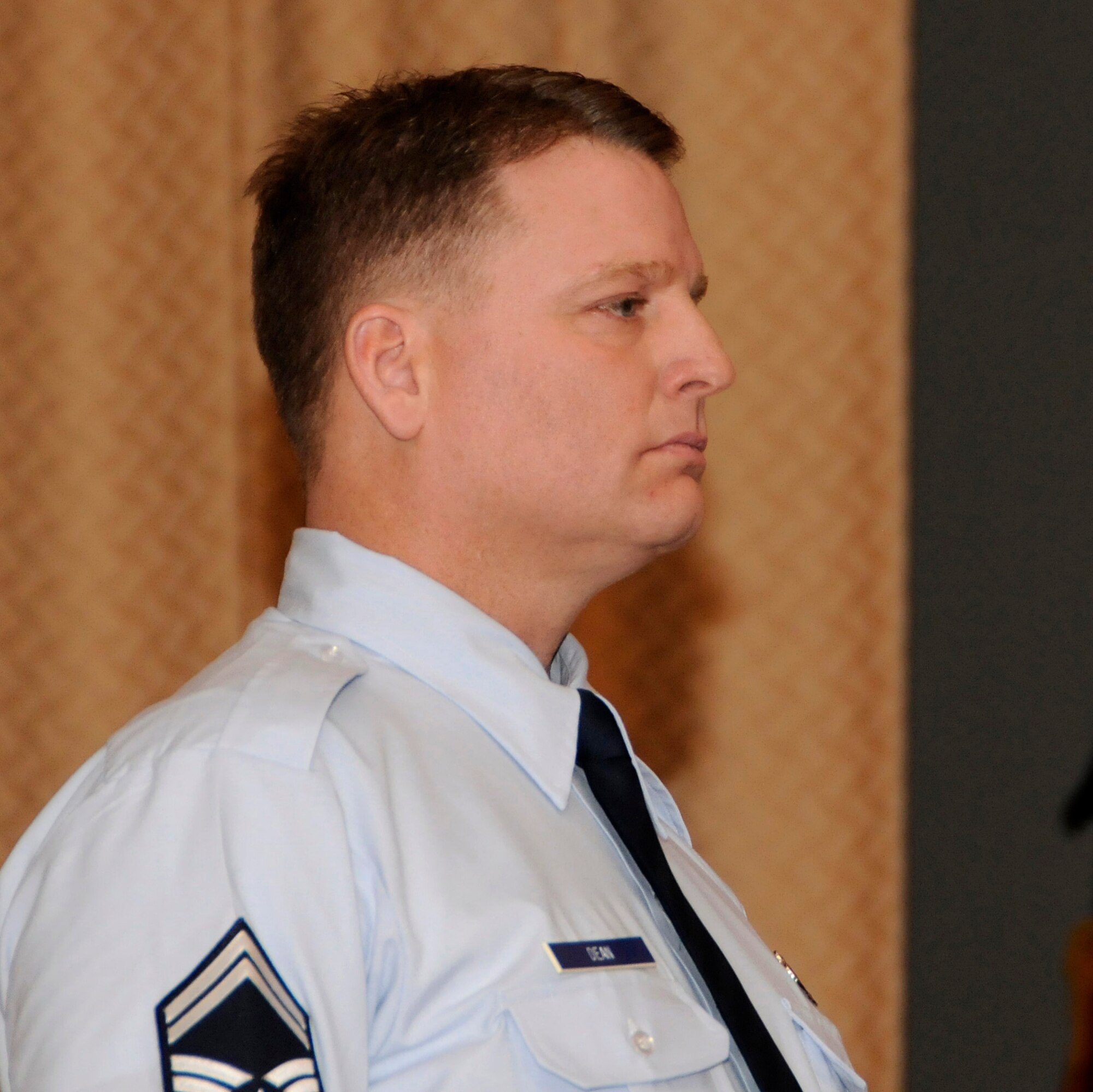 Senior Master Sgt. James Dean of the 173rd Aircraft Maintenance Squadron stands at attention as his promotion orders are read for the assembled members of the 173rd Fighter Wing during a promotion ceremony, Feb. 5, 2011, at Kingsley Field in Klamath Falls, Ore.  