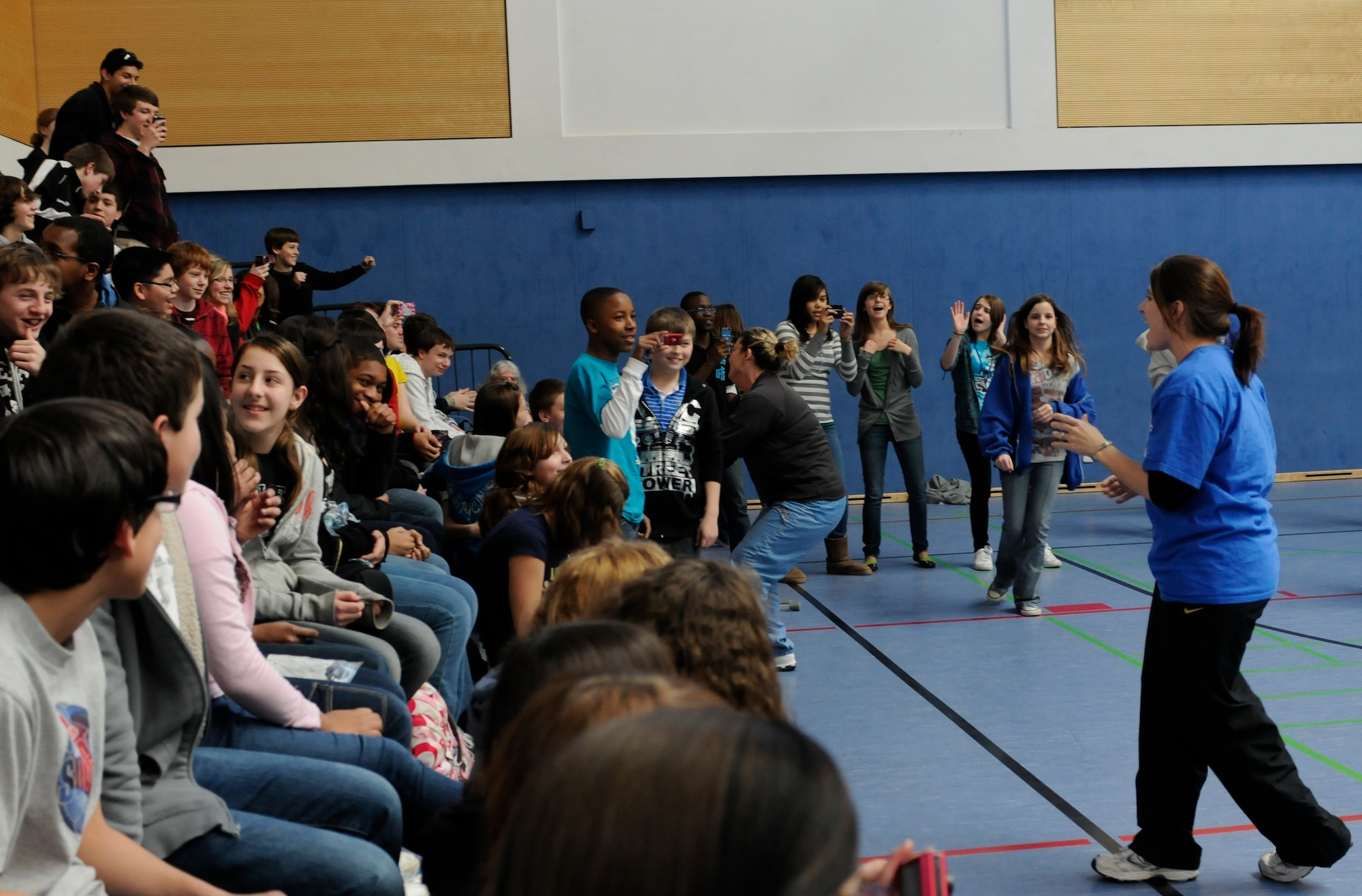 HOHENFELS, Germany – Katie Fuller, (far right) seventh and eighth grade language arts teacher, encourages students to dance during a U.S. Air Forces in Europe Band Touch ‘n Go performance at Hohenfels Middle and High School on U.S. Army Garrison Hohenfels, Germany, March 8. Touch ‘n Go performed for more than 300 students at the school as part of a Music in Our Schools tour throughout Bavaria. (U.S. Air Force photo/Staff Sgt. Kali L. Gradishar)