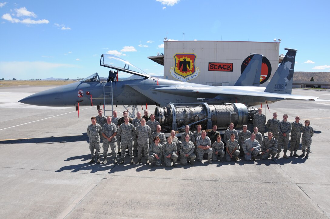 Members of the 173rd FW Maintenance shops pose with aircraft 016 and a Pratt-Whitney F100PW100 engine, Sept. 1, 2010. 
