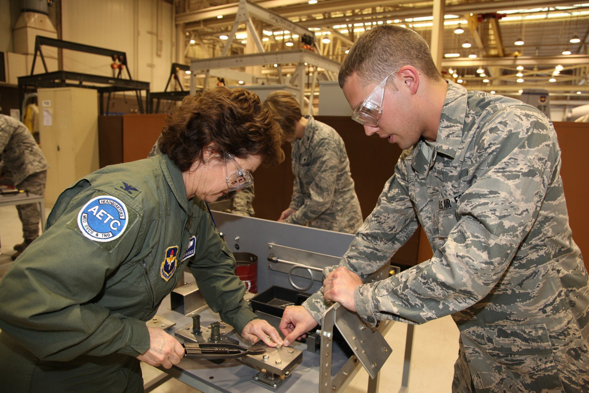 Col. Peggy Matarese, Air Education and Training Command command surgeon, works at a safety wiring table at the 361st Training Squadron March 2 during a tour at the squadron's propulsion shop. The colonel and other AETC leaders toured Sheppard as part of AETC's spring leadership conference. (U.S. Air Force photo/Airman 1st Class Adawn Kelsey)