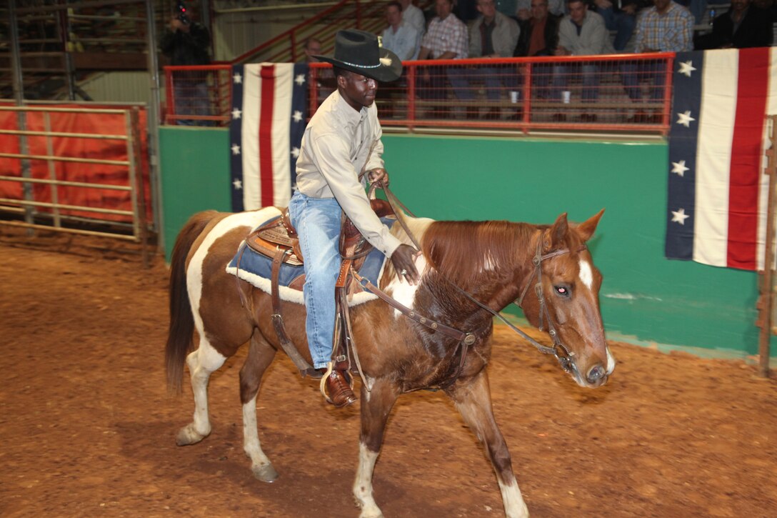 Air Education and Training Command Commander Gen. Edward Rice Jr. pats his horse March 2 after his turn at team penning during a civic event in downtown Wichita Falls, Texas. General Rice hosted this year's spring leadership conference at Sheppard Air Force Base, Texas. (U.S. Air Force photo/Airman 1st Class Adawn Kelsey)