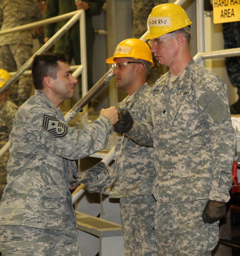 Chief Master Sgt. Ruben Gonzalez, Air Force Recruiting Service command chief, gives a soldier at the 366th Training Squadron's plumbing school a "fist pound" March 2 following a tour and training session with Airmen, Soldiers and Sailors. The chief and other Air Education and Training Command leaders attended the annual spring leadership meeting at Sheppard Feb. 28-March 3. (U.S. Air Force photo/Airman 1st Class Adawn Kelsey)