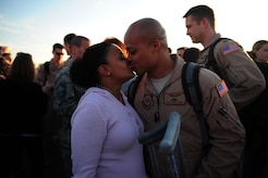 Staff Sgt. Magic Thomas greets his wife with a kiss March 3, 2011, Joint Base Charleston, S.C..   Sgt. Magic Thomas  returned from a 120-day deployment to the Middle East with the 16th Airlift Squadron. (U.S. Air Force photo by Staff. Sgt Jennifer L. Flores)(Not Reviewed)