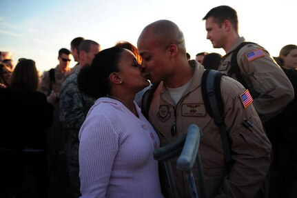 Staff Sgt. Magic Thomas greets his wife with a kiss March 3, 2011, Joint Base Charleston, S.C..   Sgt. Magic Thomas  returned from a 120-day deployment to the Middle East with the 16th Airlift Squadron. (U.S. Air Force photo by Staff. Sgt Jennifer L. Flores)(Not Reviewed)

