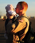 A Captain from the 16th Airlift Squadron (AS) greets his daughter on the flight line March 3, 2011, Joint Base Charleston, S.C.. Unit members of the 16th AS are returning from a 120-day deployment to the Middle East. (U.S. Air Force photo by Staff. Sgt Jennifer L. Flores)