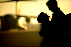 A couple embraces on the flight line as members of the 16th Airlift Squadron re-deploy March 3, 2011, Joint Base Charleston, S.C.. Airmen from the 16th Airlift Squadron are returning from a 120-day deployment to the Middle East. (U.S. Air Force photo by Staff. Sgt Jennifer L. Flores)
