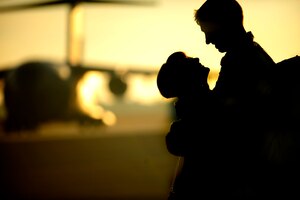 A couple embraces on the flight line as members of the 16th Airlift Squadron re-deploy March 3, 2011, Joint Base Charleston, S.C.. Airmen from the 16th Airlift Squadron are returning from a 120-day deployment to the Middle East. (U.S. Air Force photo by Staff. Sgt Jennifer L. Flores)(Not Reviewed)


