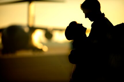 A couple embraces on the flight line as members of the 16th Airlift Squadron re-deploy March 3, 2011, Joint Base Charleston, S.C.. Airmen from the 16th Airlift Squadron are returning from a 120-day deployment to the Middle East. (U.S. Air Force photo by Staff. Sgt Jennifer L. Flores)(Not Reviewed)

