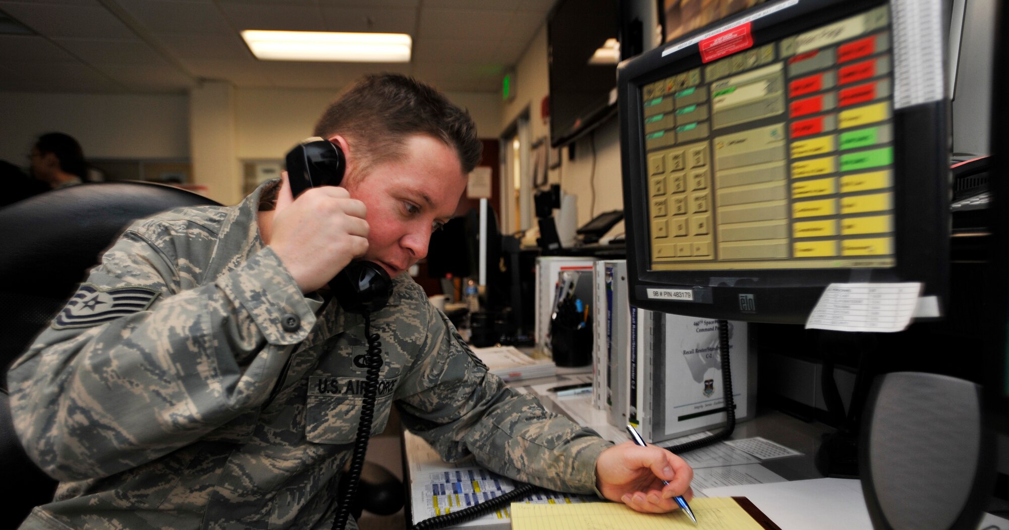 BUCKLEY AIR FORCE BASE, Colo. --Tech. Sgt. Shane Hayes, 460th Space Wing Command Post, examines through a checklist on January 25, 2011.(U.S. Air Force photo by Airman 1st Class Paul Labbe.)




