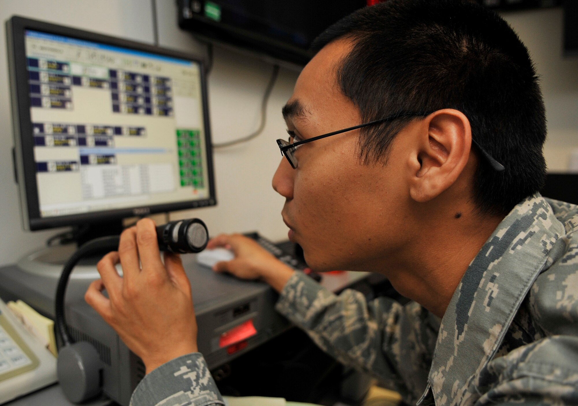 BUCKLEY AIR FORCE BASE, Colo. --Senior Airman Joshua Carandang, 460th Space Wing Command Post, speaks through a microphone on January 25, 2011.(U.S. Air Force photo by Airman 1st Class Paul Labbe.)


