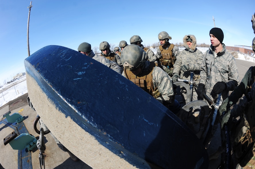 MINOT AIR FORCE BASE, N.D. -- Airmen repel down Uniform-1, a training facility on base, for Tactical Response Force training here March 4. Everyone part of the TRF team must undergo a series of training designed to push them beyond their physical limits and to evaluate how well they work under a great deal of pressure. (U.S. Air Force photo/ Airman 1st Class Aaron-Forrest Wainwright)