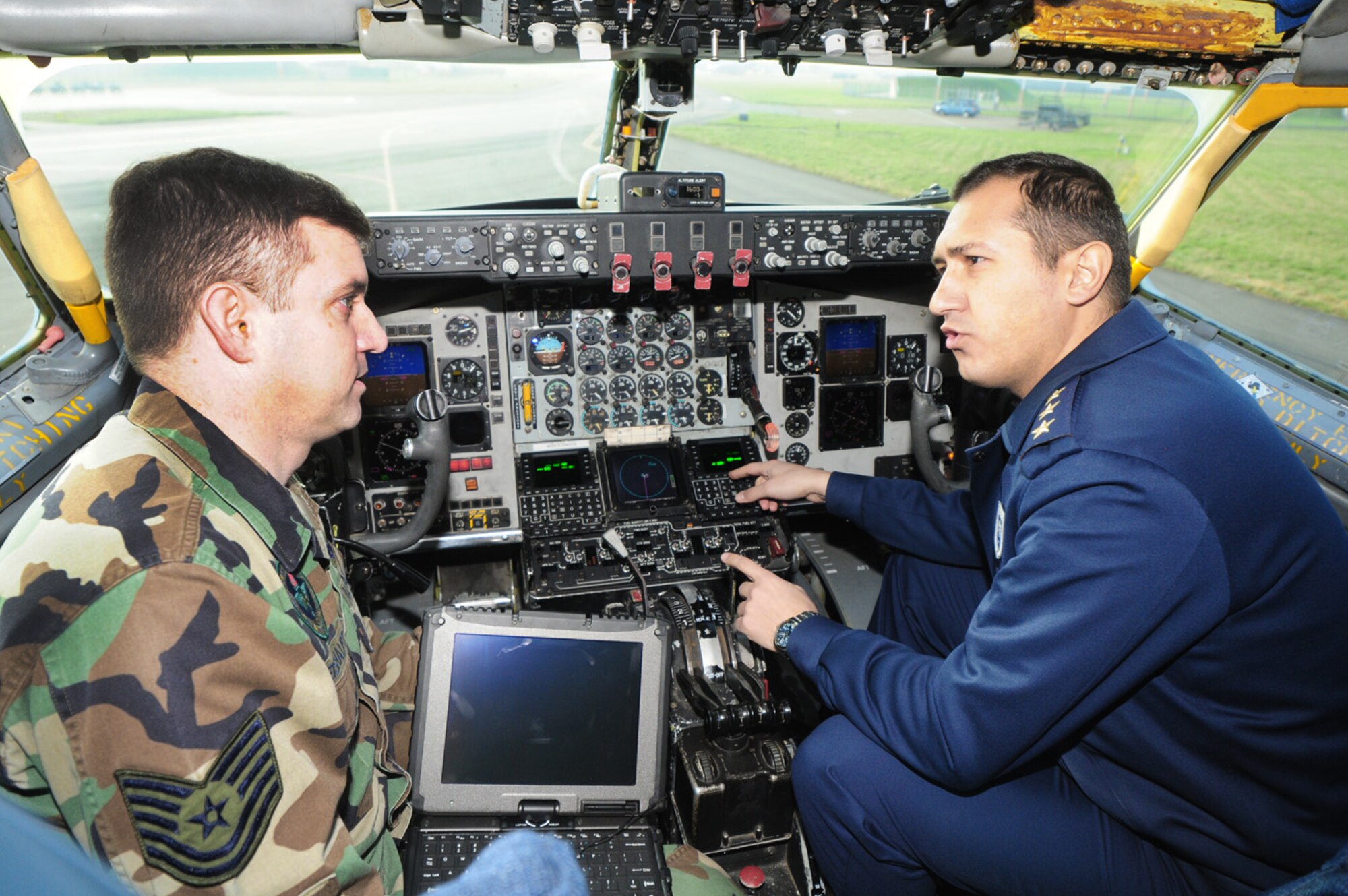 Tech. Sgt. Gary Weishaupt answers questions from a captain in the Turkish air force in the cockpit of a KC-135 Stratotanker March 2, 2011, at Royal Air Force Mildenhall, England. Several Turkish air force and civilian members were here for a two-week course, learning about the Global Air Traffic Management avionics upgrade. The Turkish airmen will receive their first upgraded jet within the next month. Sergeant Weishaupt is a 373rd Training Squadron, Det. 19 communication navigation mission systems master instructor. (U.S. Air Force photo/Karen Abeyasekere)