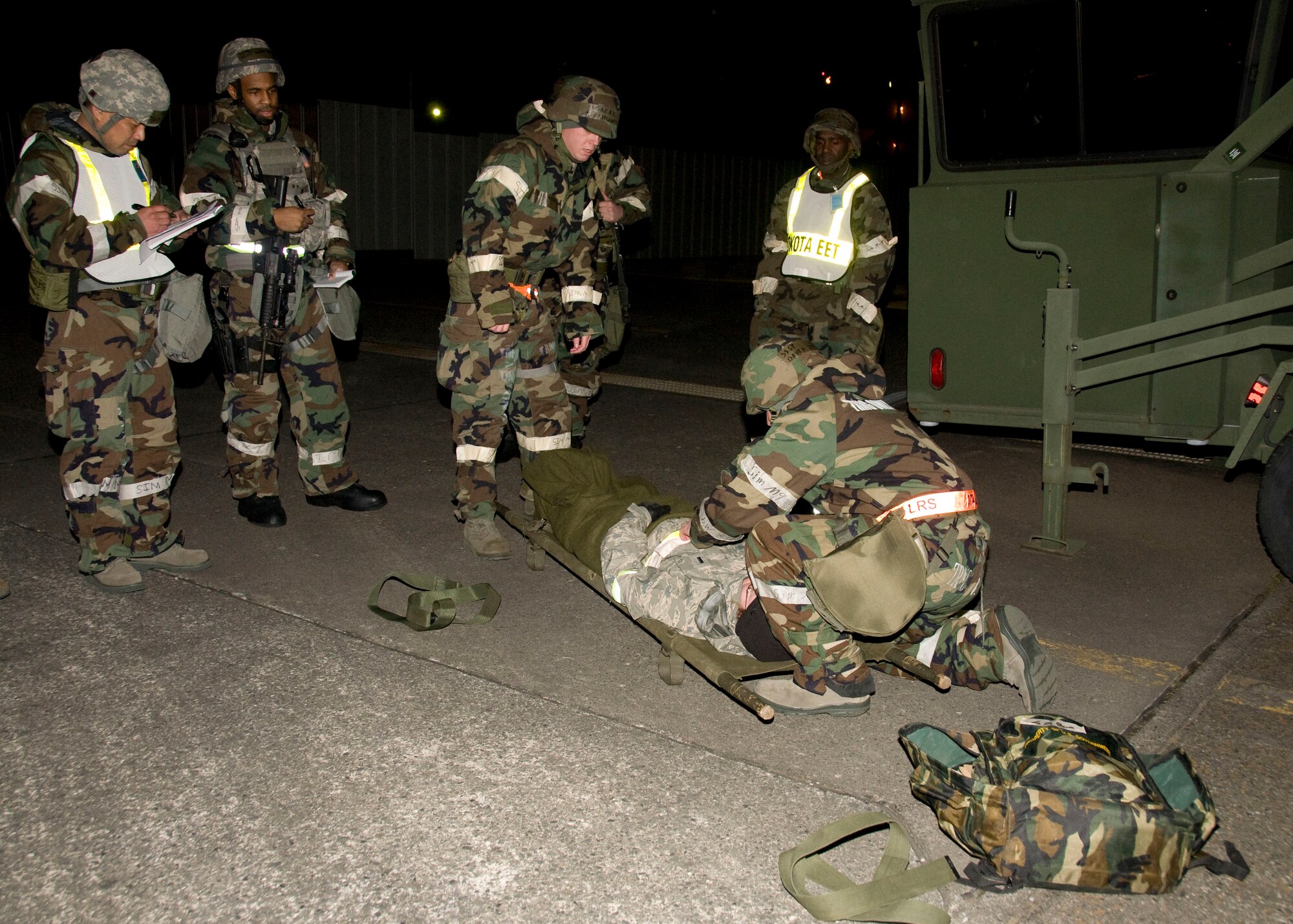YOKOTA AIR BASE, Japan -- Staff Sgt. Andrew Larson and Staff Sgt. David Stergion, 374th Logistics Readiness Squadron fuel distribution operators, prepare to transport a victim after a simulated mortar attack during an Operational Readiness Exercise here March 9. Yokota Airmen routinely train for a variety of scenarios to gain familiarity and prepare them for real-world contingencies. (U.S. Air Force photo/Airman 1st Class Andrea Salazar)
