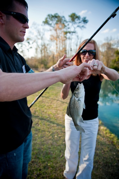 Tech. Sgt. Jeremy Phillips, 93rd Air Ground Operations Wing NCO of the Year, and his wife Keeley, unhook a fish they caught March 8 in Barney, Ga. Winners of the 2010 9th Air Force Outstanding Performers of the Year are scheduled to be announced during a banquet on March 10. (U.S. Air Force photo/Staff Sgt. Jamal D. Sutter)(RELEASED)
