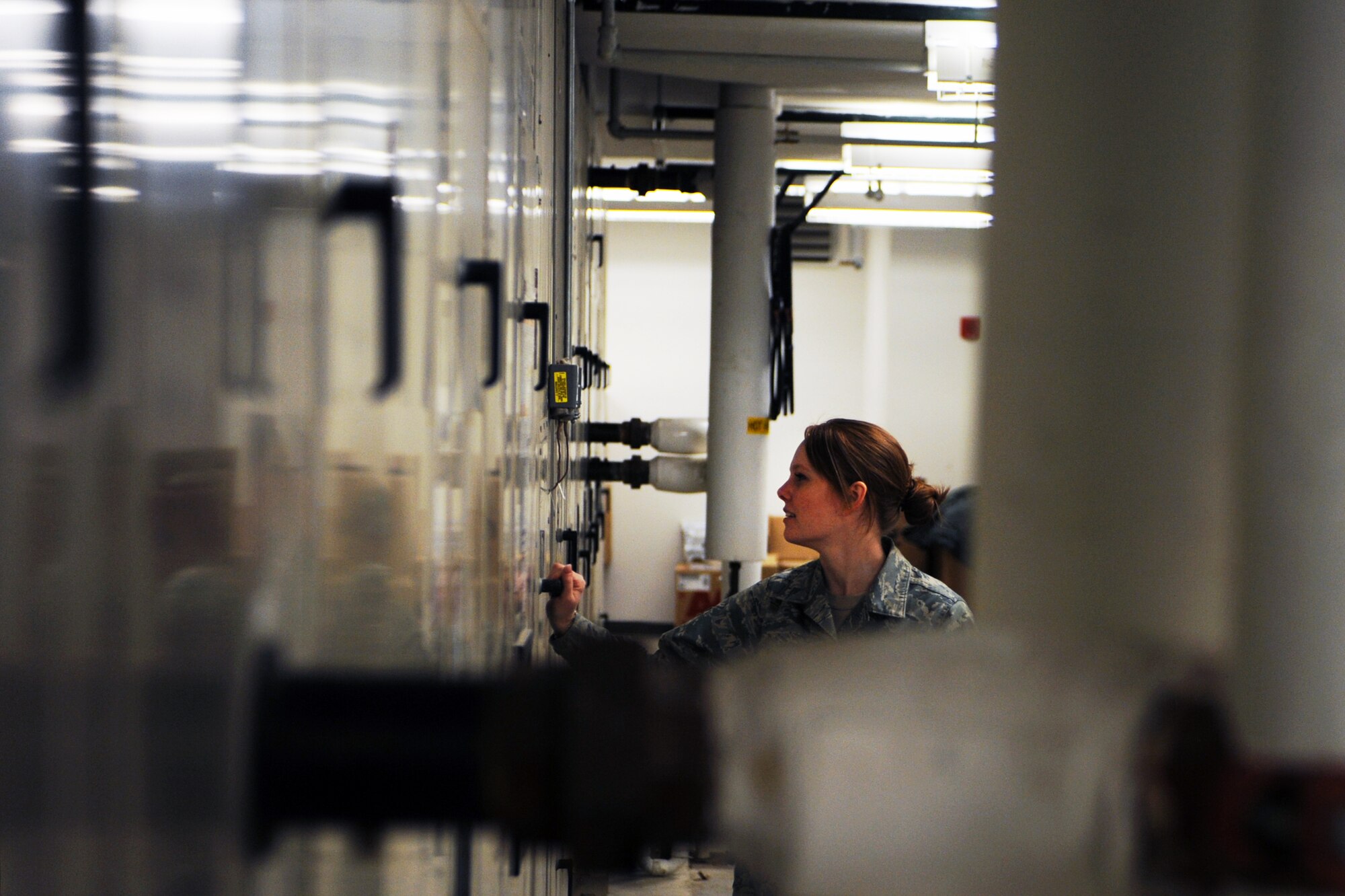 MINOT AIR FORCE BASE, N.D. -- Senior Airman Natasha Ashley, 5th Force Support Squadron fitness specialist, examines the ventilation system’s air pressure at the McAdoo Fitness Center here Mar. 8. Operating innovative technologies which focus on energy conservation has been a top priority for Air Force Global Strike Command and leadership throughout the Air Force worldwide. (U.S. Air Force photo/Airman 1st Class Aaron-Forrest Wainwright)


