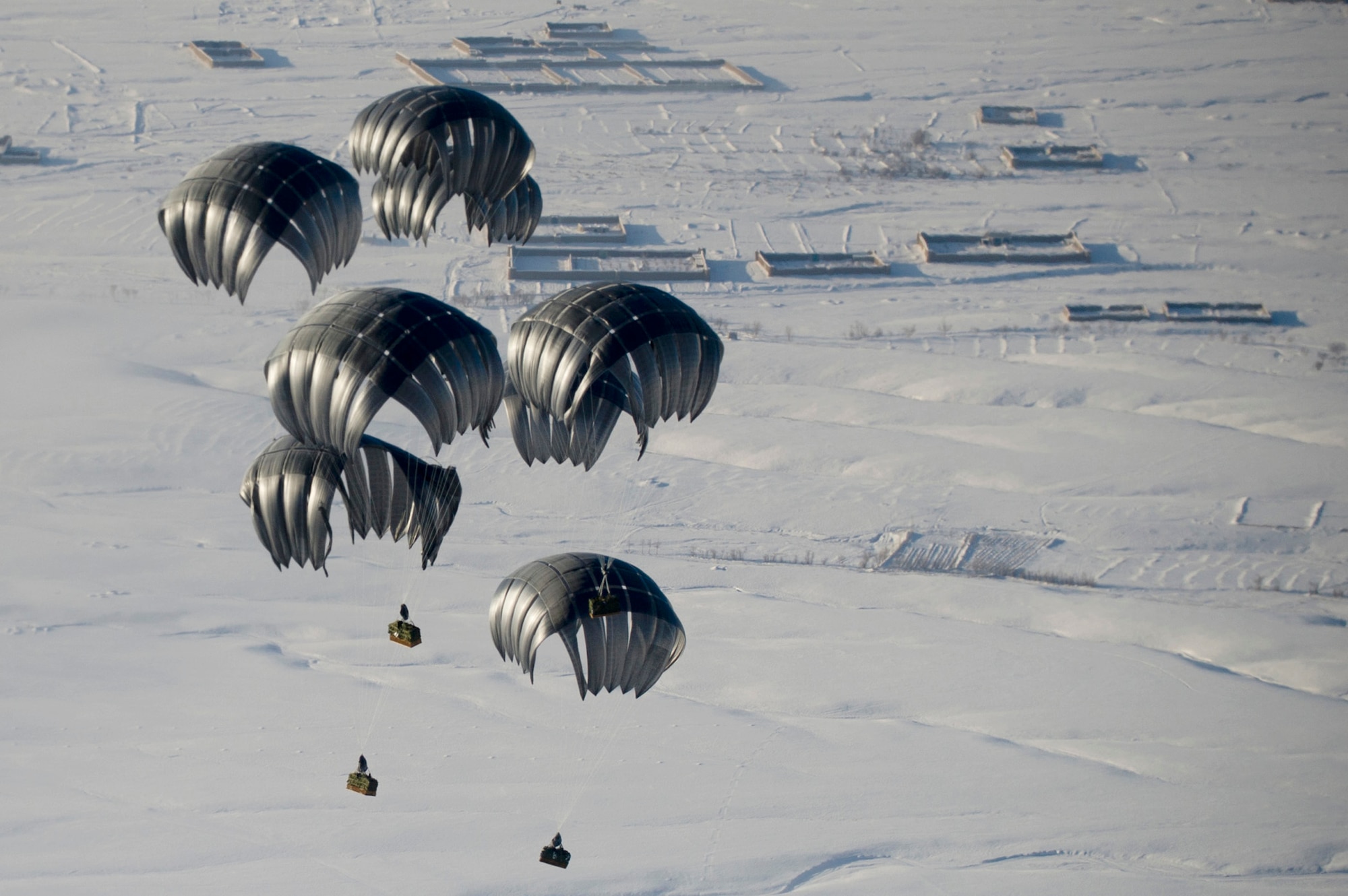 Air delivery cargo is airdropped Mar. 3, 2011, to a remote operating base in Afghanistan. (U.S. Air Force photo/Master Sgt. Adrian Cadiz)
