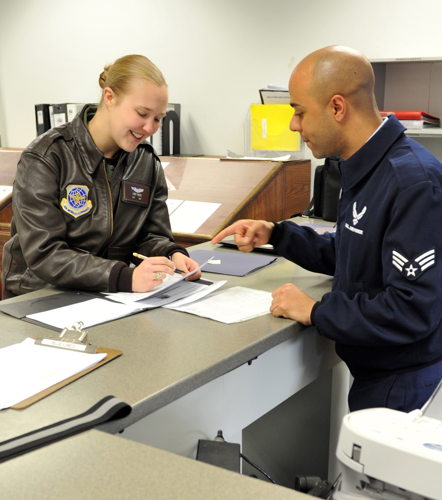 Senior Airman Kyle Jefferson (right), a 41st Airlift Squadron instructor loadmaster, reviews “go no-go” paperwork with Capt. Elizabeth Music, a 41st AS pilot, at Little Rock Air Force Base, Ark., March 7, 2011. The Wyoming, Mich., native recently upgraded to instructor loadmaster ahead of his peers. (U.S. Air Force photo by Airman 1st Class Rusty Frank)