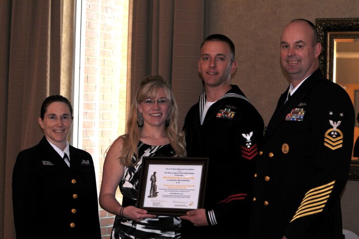The Navy League Charleston recently honored local area Sailors of the Year at a ceremony held on Joint Base Charleston - Weapons Station. Pictured (left to right) after receiving his award are Lt. Cmdr. Erica Hoffman, executive officer of Nuclear Power Training Unit, Mrs. Howart, Machinist's Mate 1st Class Nicholas Howart, NPTU Sailor of the Year and Master Chief Petty Officer, Wayne Robbins, NPTU command master chief.
