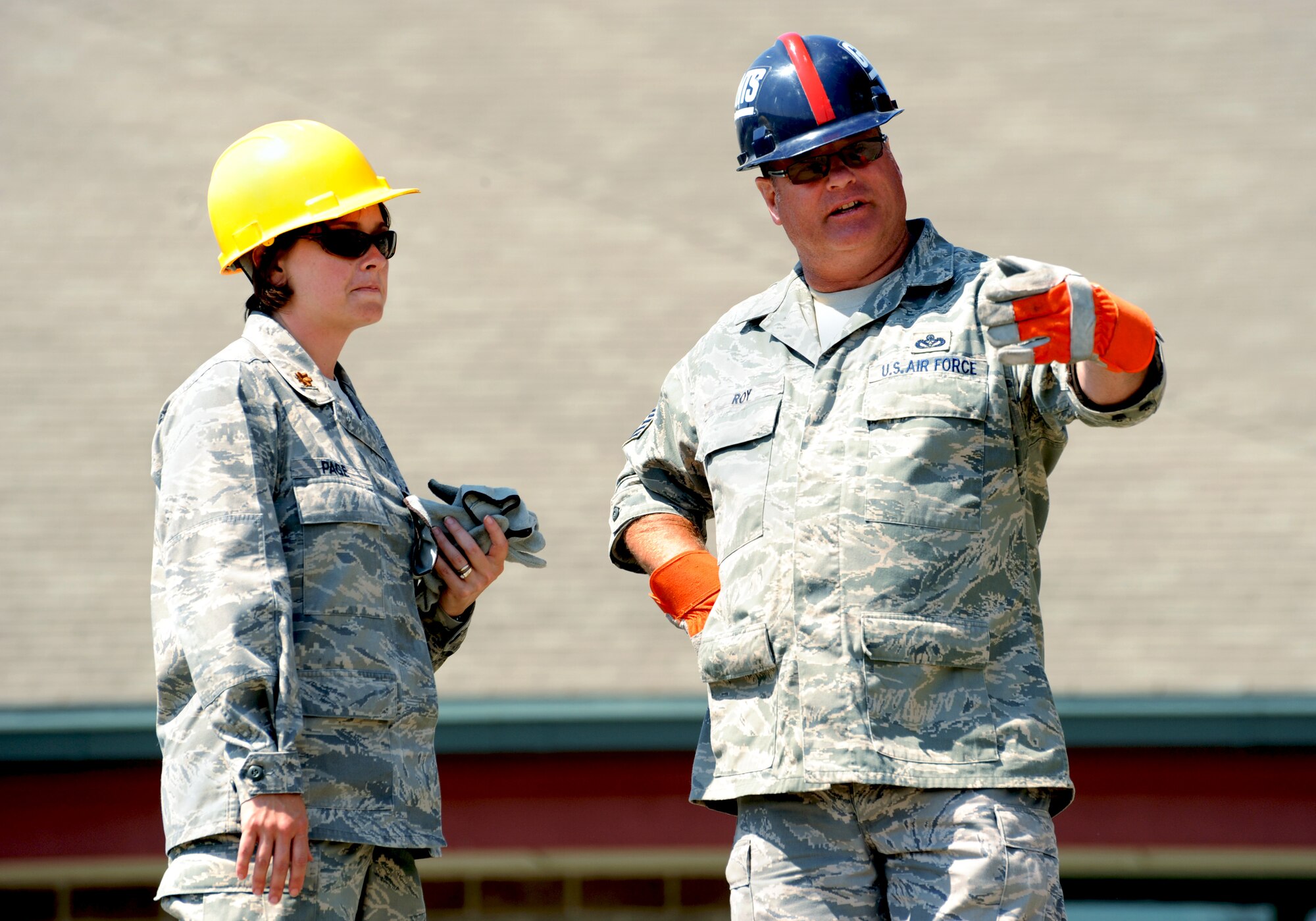 Oregon Air National Guard Senior Master Sgt. Jeff Roy, 142nd Civil Engineer Squadron, points out the progress of the Jeff Lucas Veterans Memorial Stadium to Major Mededith Page, acting Commander of the 142nd CES during the two weeks of work the 142nd CES spent building the new sports complex. (U.S. Air Force photograph by Tech. Sgt. John Hughel, 142nd Public Affairs)