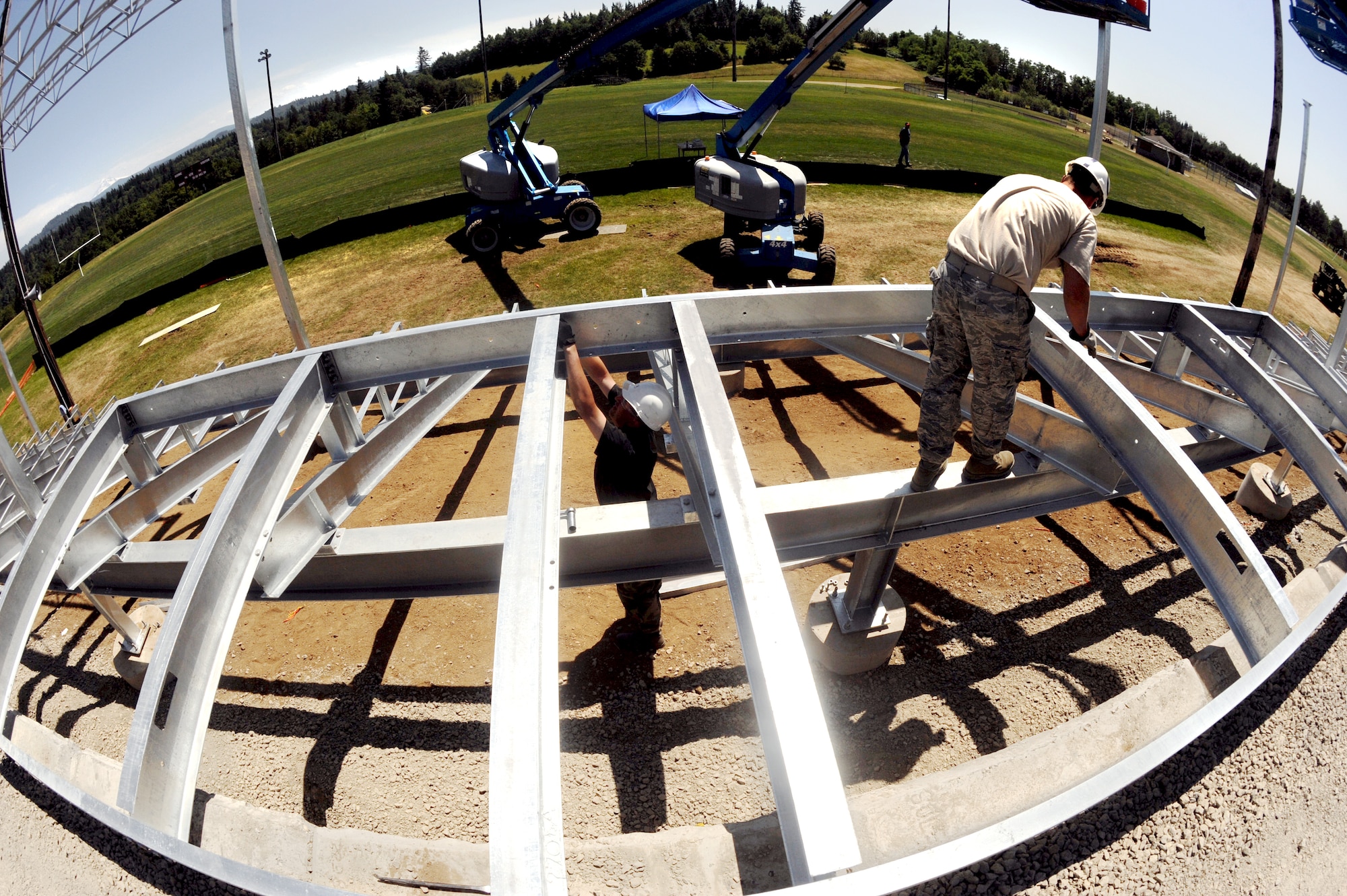 Oregon Air National Guard Airmen from the 142nd Civil Engineers Squadron work on the Jeff Lucas Veterans Memorial Stadium at Corbett High School, Corbett, Ore. The new stadium and sports complex, brought together members of the local community and the Airmen of the 142nd CES, who committed over 500 hours of construction time to the finished project. (U.S. Air Force photograph by Tech. Sgt. John Hughel, 142nd Fighter Wing Public Affairs)