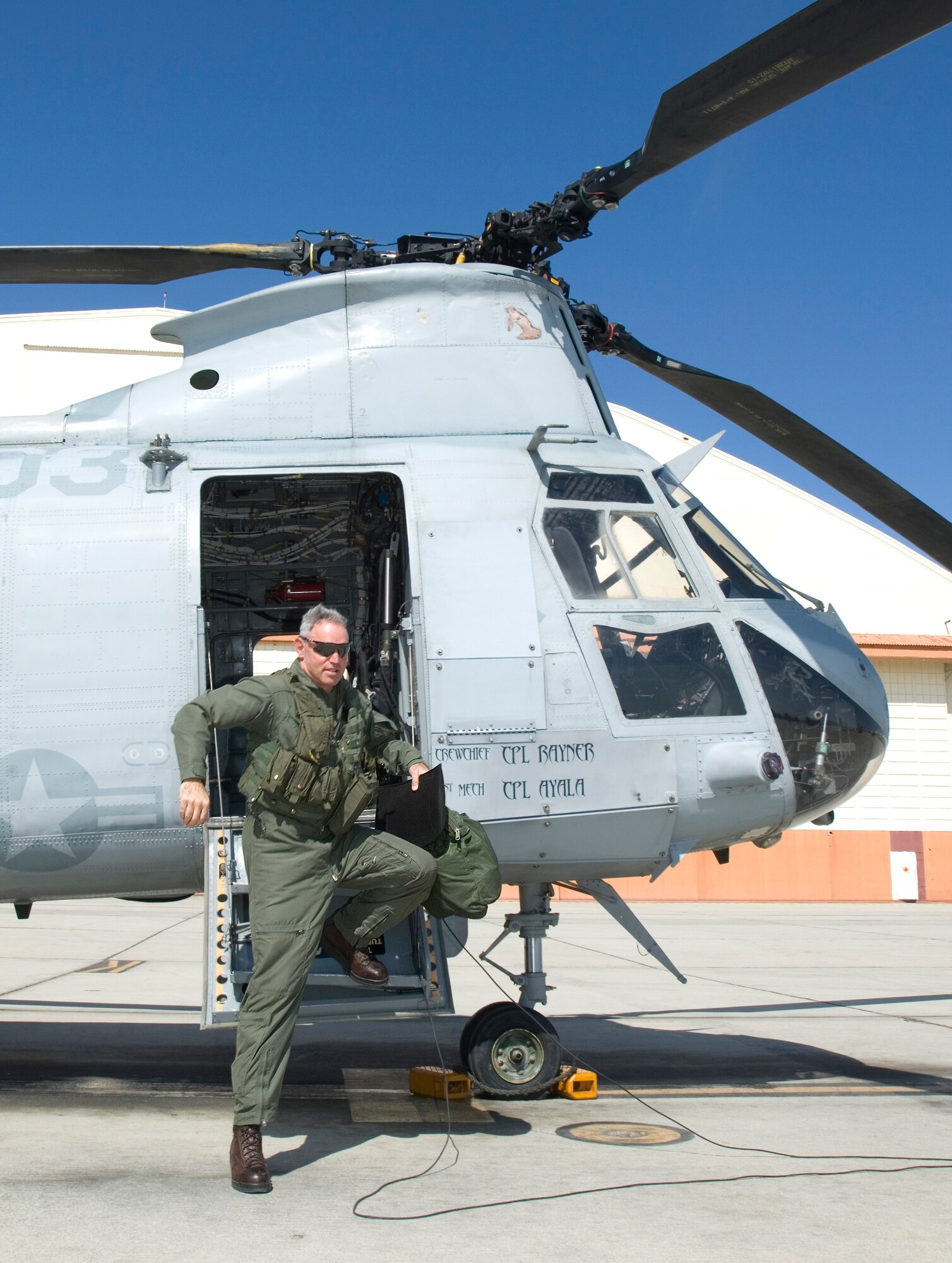 Marine Lt. Col. Marcus Malais steps out of a CH-46 Sea Knight following his final qualification flight. Colonel Malais relinquished command of Marine Medium Helicopter Squadron 764 to Lt. Col. Scott A. Craig during a change of command ceremony Mar. 5. Colonel Malais plans to remain with HMM-764 until his upcoming retirement. (Air Force photo by Edward Cannon)