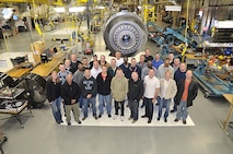 Airmen of the 916th Air Refueling Wing stand in front of the most powerful commercial jet engine in the world, the G90/115B at the GE Aircraft Engine facility in Research Triangle Park.(Photo courtesy of Mr. Elias Diaz, GE Durham)